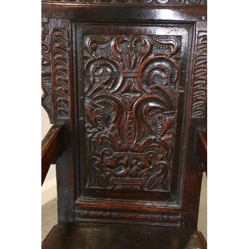 459 - A 17th century carved oak wainscot armchair with scroll panel back, on turned and stretchered suppor... 