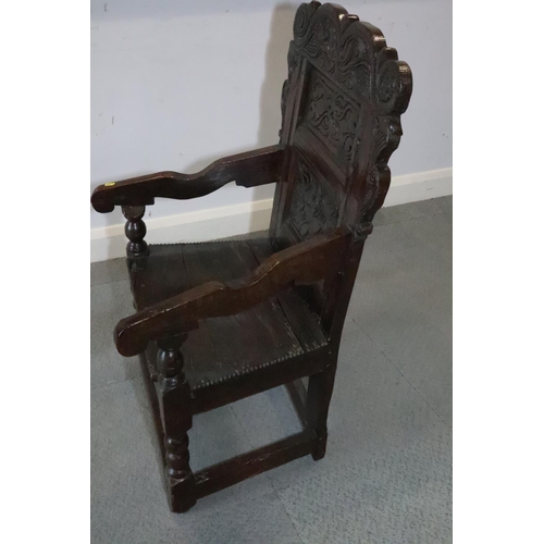 460 - A mid 17th century carved oak wainscot armchair with two-panel back, on turned and stretchered suppo... 