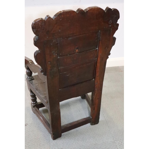 460 - A mid 17th century carved oak wainscot armchair with two-panel back, on turned and stretchered suppo... 