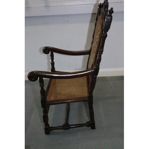 463 - A late 17th century carved oak open armchair with padded back and cane seat, and loose seat cushion,... 