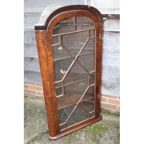 464 - An early 18th century walnut archtop corner cabinet enclosed lattice glazed door, 27