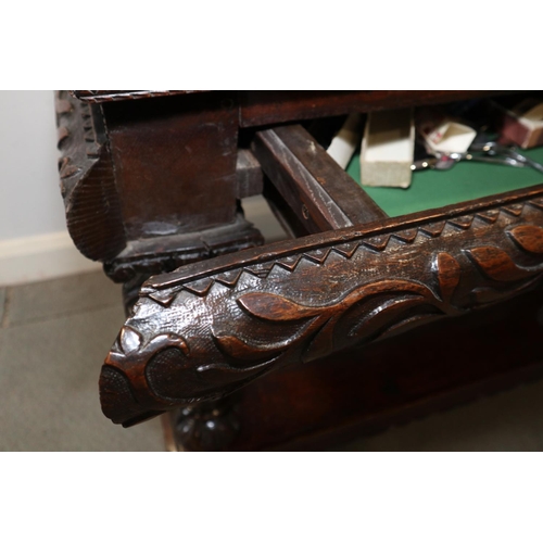 465 - An early 17th century carved oak buffet/court cupboard with griffins, caryatids and herms, frieze ce... 