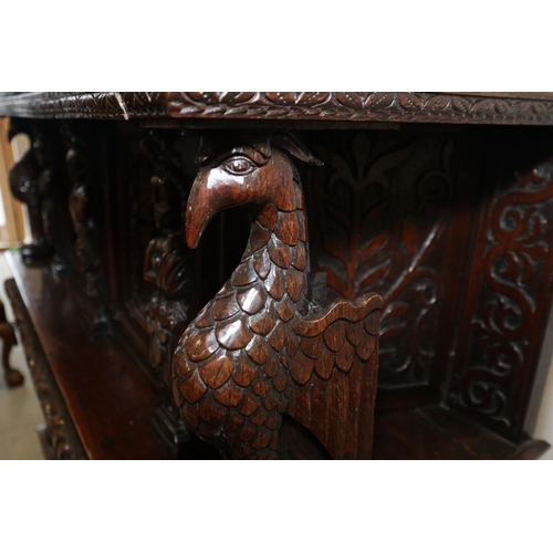 465 - An early 17th century carved oak buffet/court cupboard with griffins, caryatids and herms, frieze ce... 