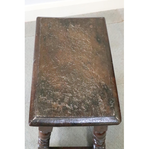 467 - A late 17th century oak joint stool, on turned and stretchered supports, seat underside stamped W P ... 