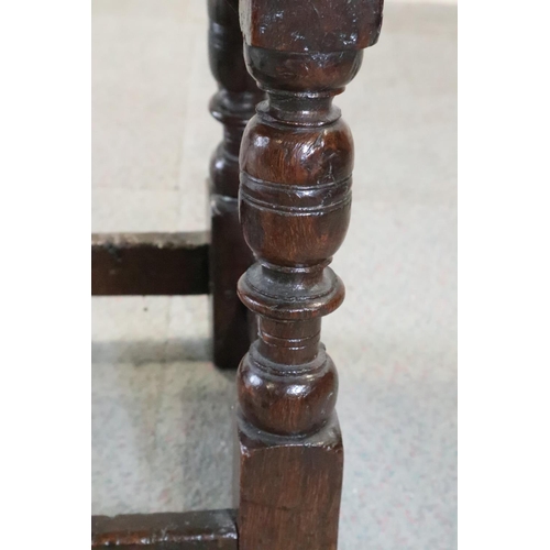 467 - A late 17th century oak joint stool, on turned and stretchered supports, seat underside stamped W P ... 