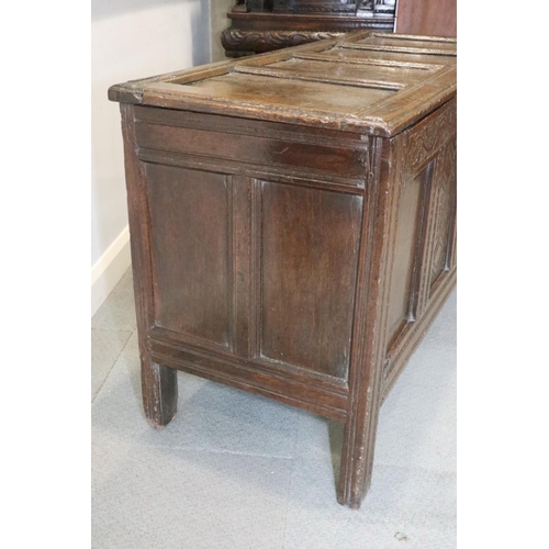 472 - A late 17th century carved oak four panel front coffer, dated 1693, on stile supports, 52