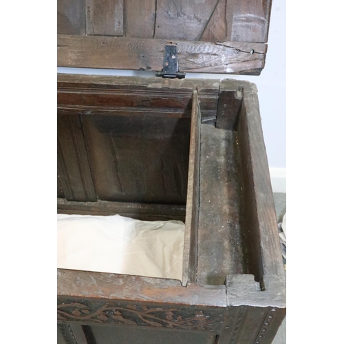 472 - A late 17th century carved oak four panel front coffer, dated 1693, on stile supports, 52