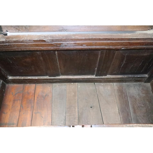 472 - A late 17th century carved oak four panel front coffer, dated 1693, on stile supports, 52