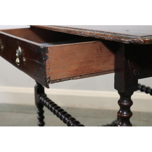 475 - An 18th century oak side table, fitted one drawer with brass drop handles, on bobbin turned and stre... 