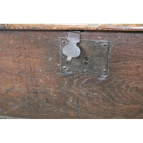 476 - A 17th century oak boarded coffer, on panel end supports, 51