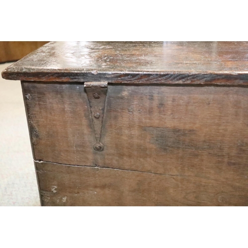 476 - A 17th century oak boarded coffer, on panel end supports, 51