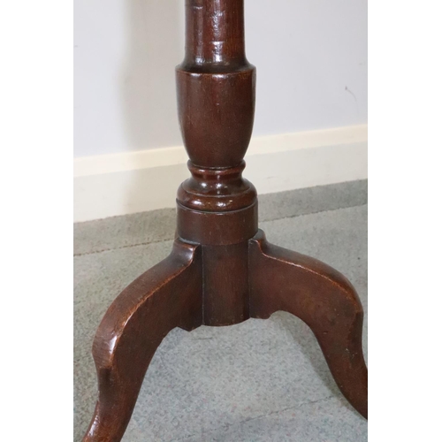 479 - An 18th century oak circular occasional table, on baluster column and tripod splay support, 21 3/4