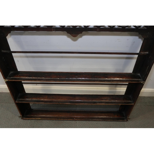 480 - An 18th century oak wall hanging plate rack with pierced frieze, 46