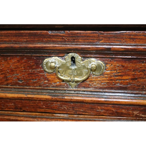 487 - An early 18th century oak chest of two short and three long drawers  (one shallow and two deep) with... 