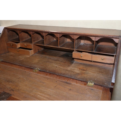 489 - A late 18th century oak fall front bureau with fitted interior over two short and three long graduat... 