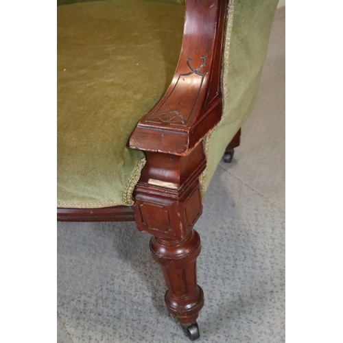 493 - A 19th century mahogany showframe armchair, button upholstered in a green velvet, on turned and cast... 