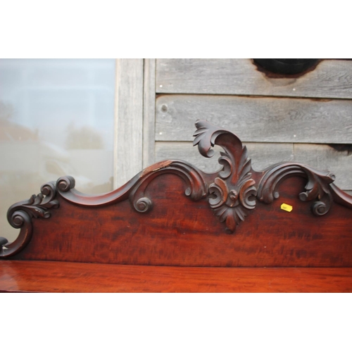 500 - A Victorian mahogany chiffonier with carved ledge back over two drawers and cupboards, on block base... 