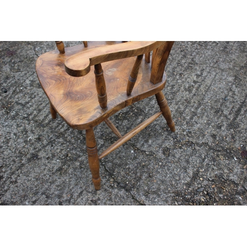 535 - A Windsor lath back farmhouse elbow chair, with elm panel seat, on turned and stretchered supports