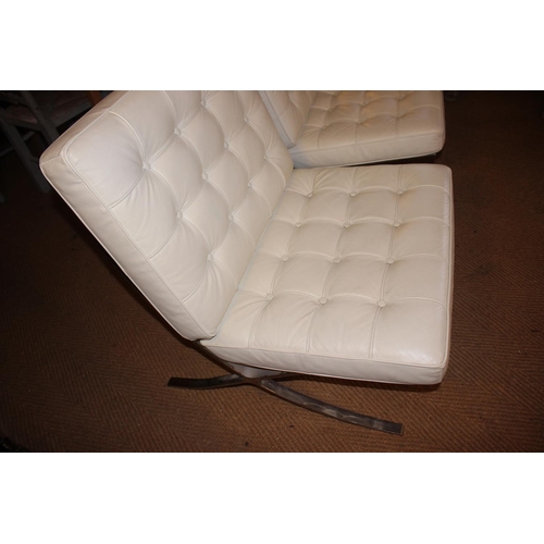 543 - A pair of chrome framed Barcelona chairs, button upholstered in a white leather