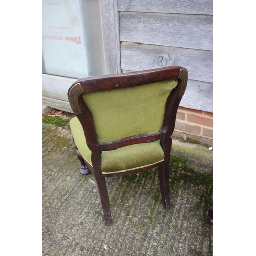 560 - A Victorian style polished as mahogany low seat nursing chair, upholstered in a green velour, on ree... 