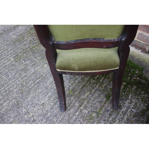 560 - A Victorian style polished as mahogany low seat nursing chair, upholstered in a green velour, on ree... 