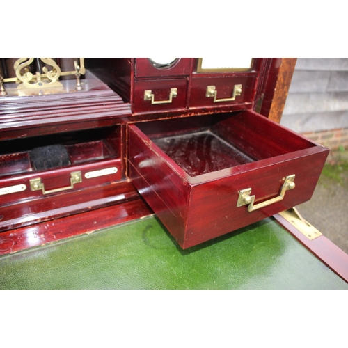 562 - A 1930s burr walnut fall front secretaire desk with fitted interior, including postal scales, barome... 