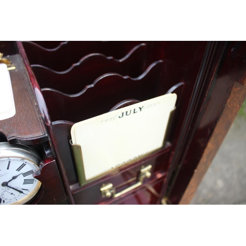 562 - A 1930s burr walnut fall front secretaire desk with fitted interior, including postal scales, barome... 