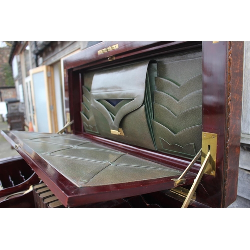 562 - A 1930s burr walnut fall front secretaire desk with fitted interior, including postal scales, barome... 