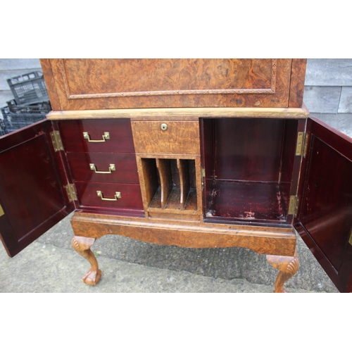 562 - A 1930s burr walnut fall front secretaire desk with fitted interior, including postal scales, barome... 