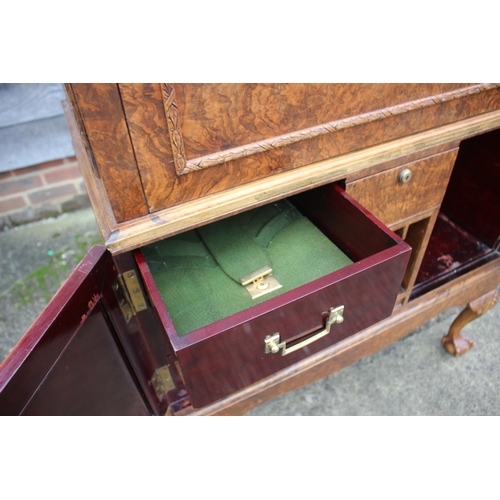 562 - A 1930s burr walnut fall front secretaire desk with fitted interior, including postal scales, barome... 