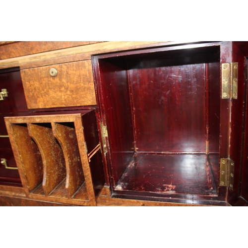 562 - A 1930s burr walnut fall front secretaire desk with fitted interior, including postal scales, barome... 