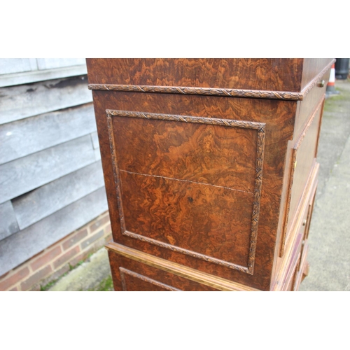 562 - A 1930s burr walnut fall front secretaire desk with fitted interior, including postal scales, barome... 