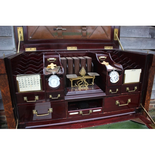 562 - A 1930s burr walnut fall front secretaire desk with fitted interior, including postal scales, barome... 