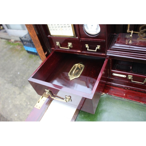 562 - A 1930s burr walnut fall front secretaire desk with fitted interior, including postal scales, barome... 