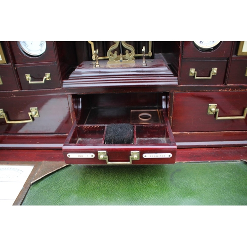 562 - A 1930s burr walnut fall front secretaire desk with fitted interior, including postal scales, barome... 