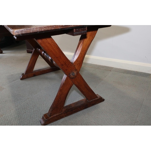 563 - An antique pitch pine refectory table, on chamfered 'X' frame supports, 54