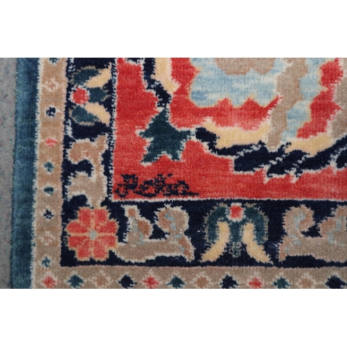 568 - An Indian Burdur wool carpet with all-over palmette design on a blue ground, multi-bordered in shade... 