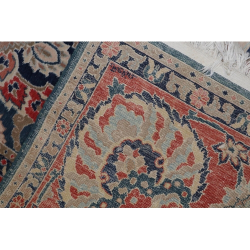 568 - An Indian Burdur wool carpet with all-over palmette design on a blue ground, multi-bordered in shade... 