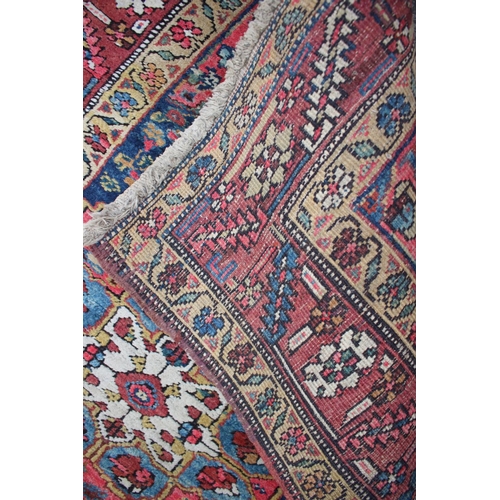 575 - A Karafa runner with three floral medallions on a blue ground and triple bordered in shades of red, ... 