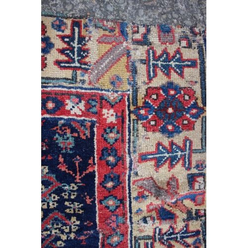 576 - An antique Caucasian/Kurdish rug with all-over tree design on a blue ground (patched, cut and repair... 