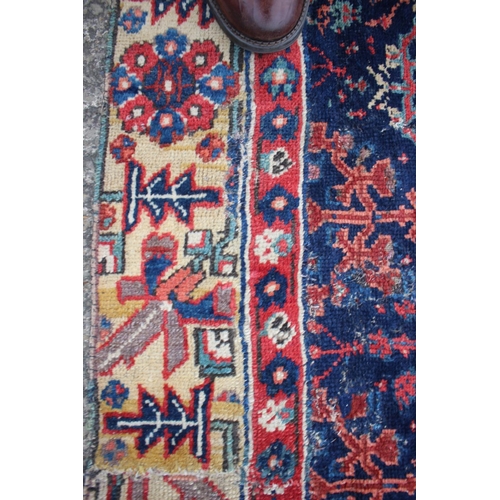 576 - An antique Caucasian/Kurdish rug with all-over tree design on a blue ground (patched, cut and repair... 