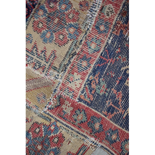 576 - An antique Caucasian/Kurdish rug with all-over tree design on a blue ground (patched, cut and repair... 