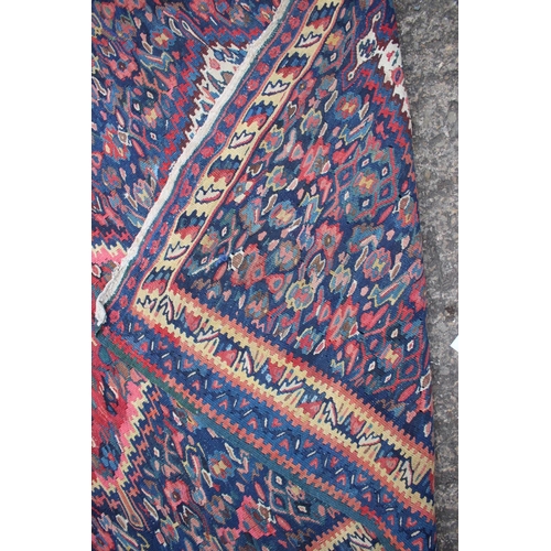 579 - A Senneh kelim rug with all-over three medallion and floral design on a blue ground, 44