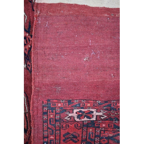 582 - A Bokhara bag face with nine medallions on a red ground, 29 1/2