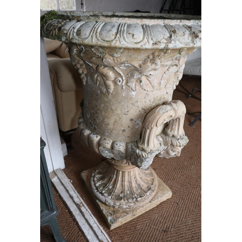 586 - A 19th century pale terracotta two-handled campana urn with vine relief decoration, on square base, ... 