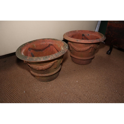 589 - A pair of terracotta swag decorated garden urns, 18