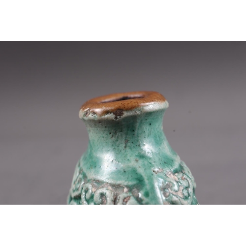 105 - A Chinese green glazed ceramic relief dragon decorated snuff bottle, 2 3/4