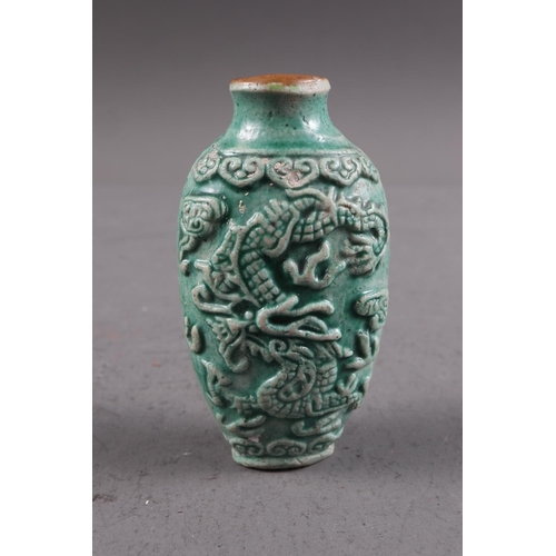 105 - A Chinese green glazed ceramic relief dragon decorated snuff bottle, 2 3/4