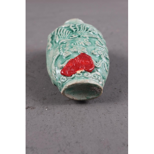 105 - A Chinese green glazed ceramic relief dragon decorated snuff bottle, 2 3/4