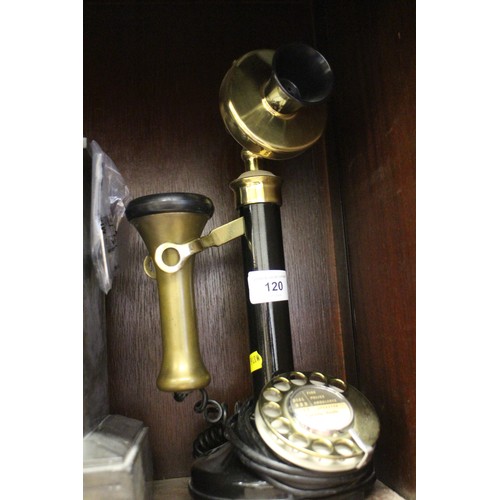 120 - A rotary candlestick black and brass mounted telephone and a slate mantel clock with enamelled dial ... 